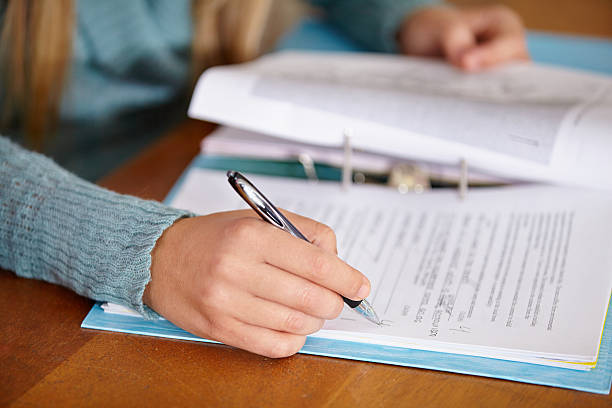 Close up of a teacher marking a test