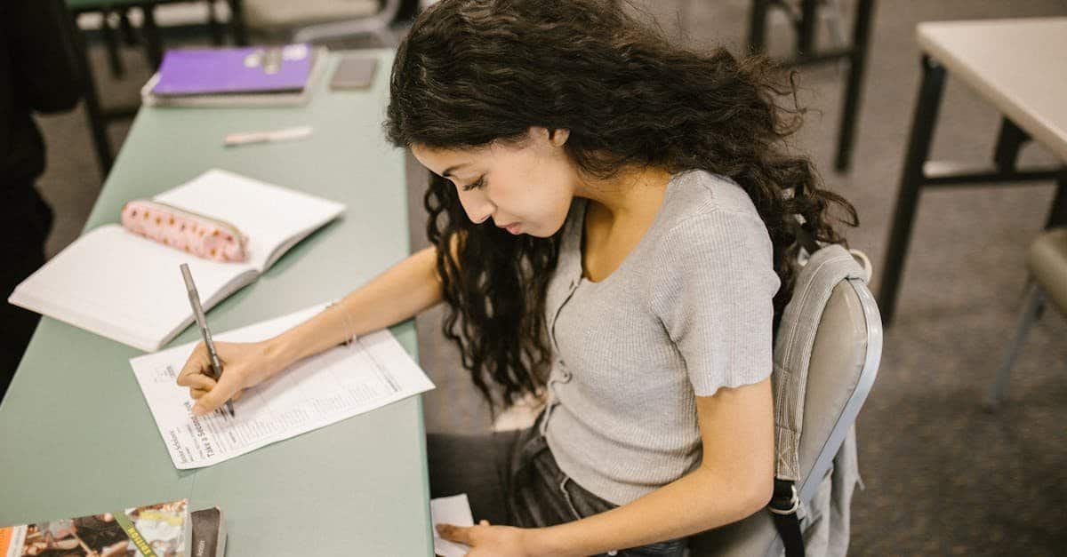 Person writing an IELTS General Writing Task 1 letter, showing focus and determination